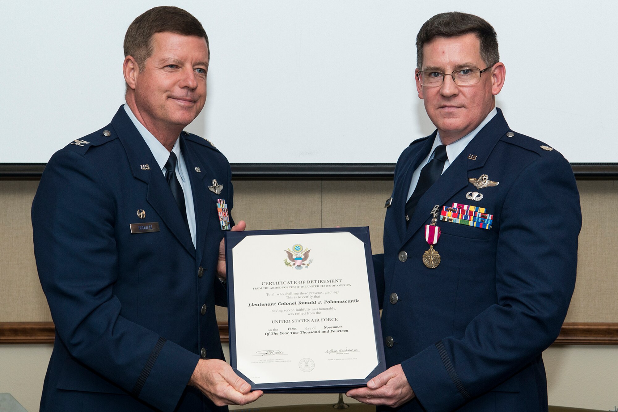 U.S. Air Force Lt. Col. Ronald Polomoscanik (right) is presented his retirement certificate during a ceremony on Nov. 2, 2014, Barksdale Air Force Base, La. Polomoscanik is the Director of Operations for the 343rd Bomb Squadron and is retiring from the Air Force Reserve. (U.S. Air Force photo by Master Sgt. Greg Steele/Released)