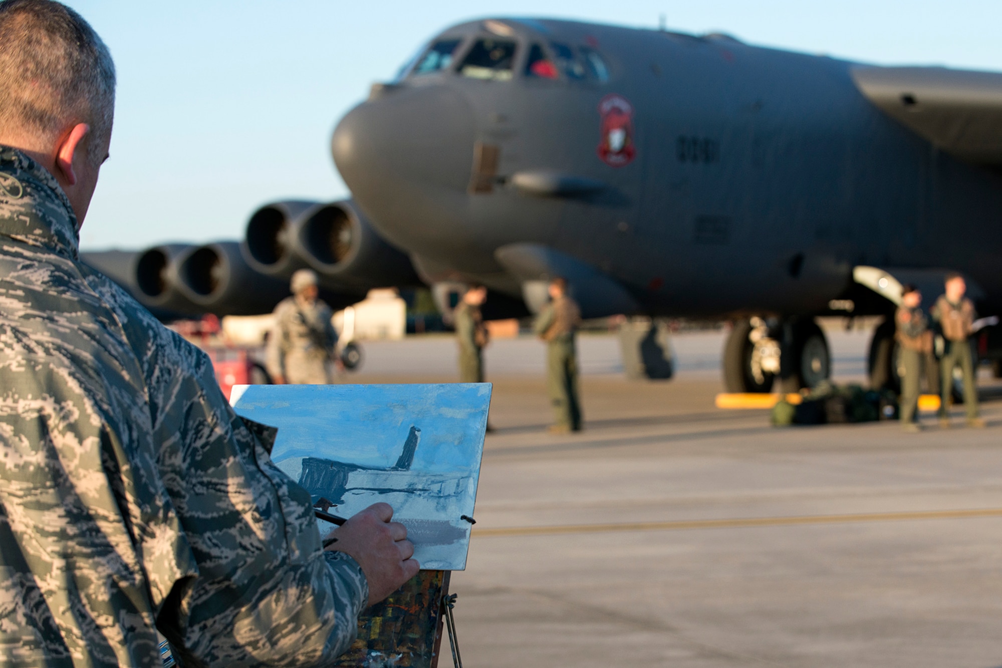 U.S. Air Force Maj. Warren Neary does a rough painting of a 307th Bomb Wing B-52H Stratofortress during his visit on Nov. 2, 2014, Barksdale Air Force Base, La. Members of the 343rd Bomb Squadron, 707th Maintenance Squadron and the 307th Security Forces Squadron were used for the painting. (U.S. Air Force photo by Master Sgt. Greg Steele/Released)