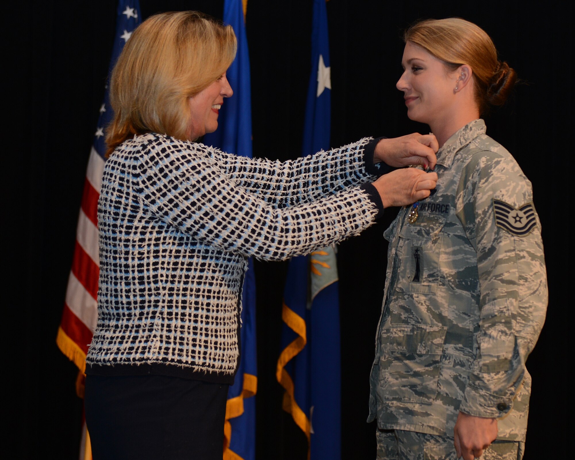 Secretary of the Air Force Deborah Lee James presents the Nuclear Deterrence Operations Service Medal to Tech. Sgt. Erin Bernik, a B-52 weapons loader from the 707th Maintenance Squadron, on Nov. 5, 2014, Barksdale Air Force Base, La. Bernik, representing the 307th Bomb Wing, received the medal during the Air Force Global Strike Command's 2014 Global Strike Challenge. (U.S. Air Force photo by Senior Airman Benjamin Gonsier/Released)