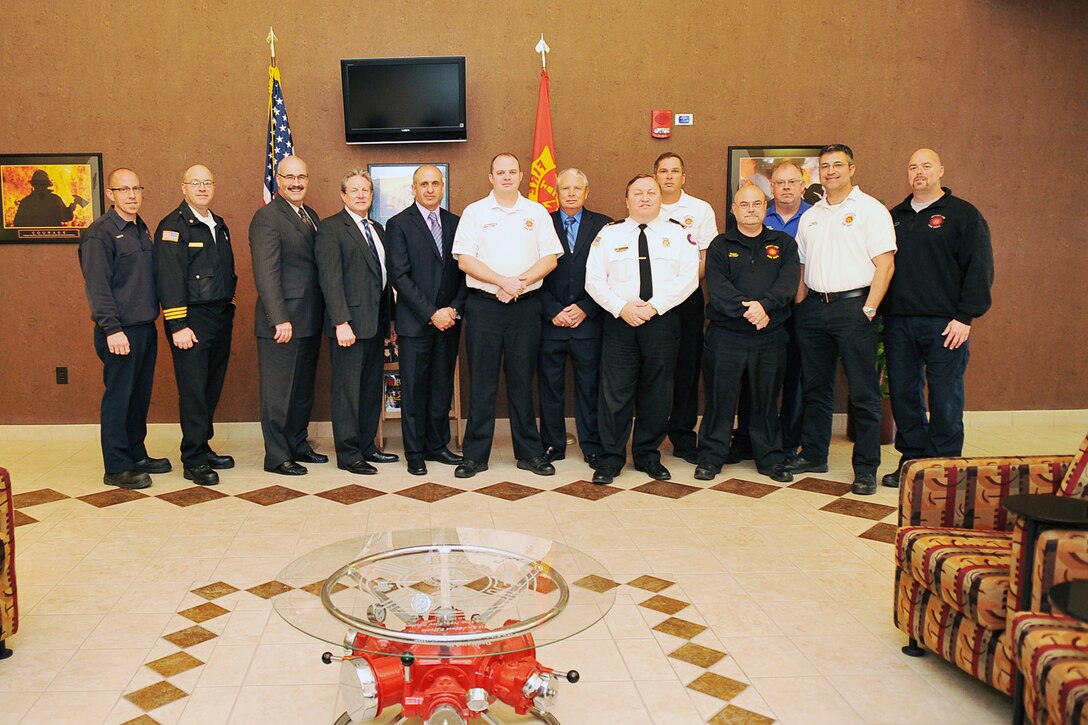 Members of the Offutt Fire Department pose with four assessors from the Commission on Fire Accreditation International following a three-and-a-half day look behind the scenes at the unit on Nov. 5, Offutt Air Force Base, Neb. After a two-year process, the department was recommended for an accreditation and becomes the fortieth fire department within the Department of Defense, the fourteenth within the Air Force, and one of only 195 worldwide to earn the accreditation. (U.S. Air Force photo by Charles Haymond/Released)