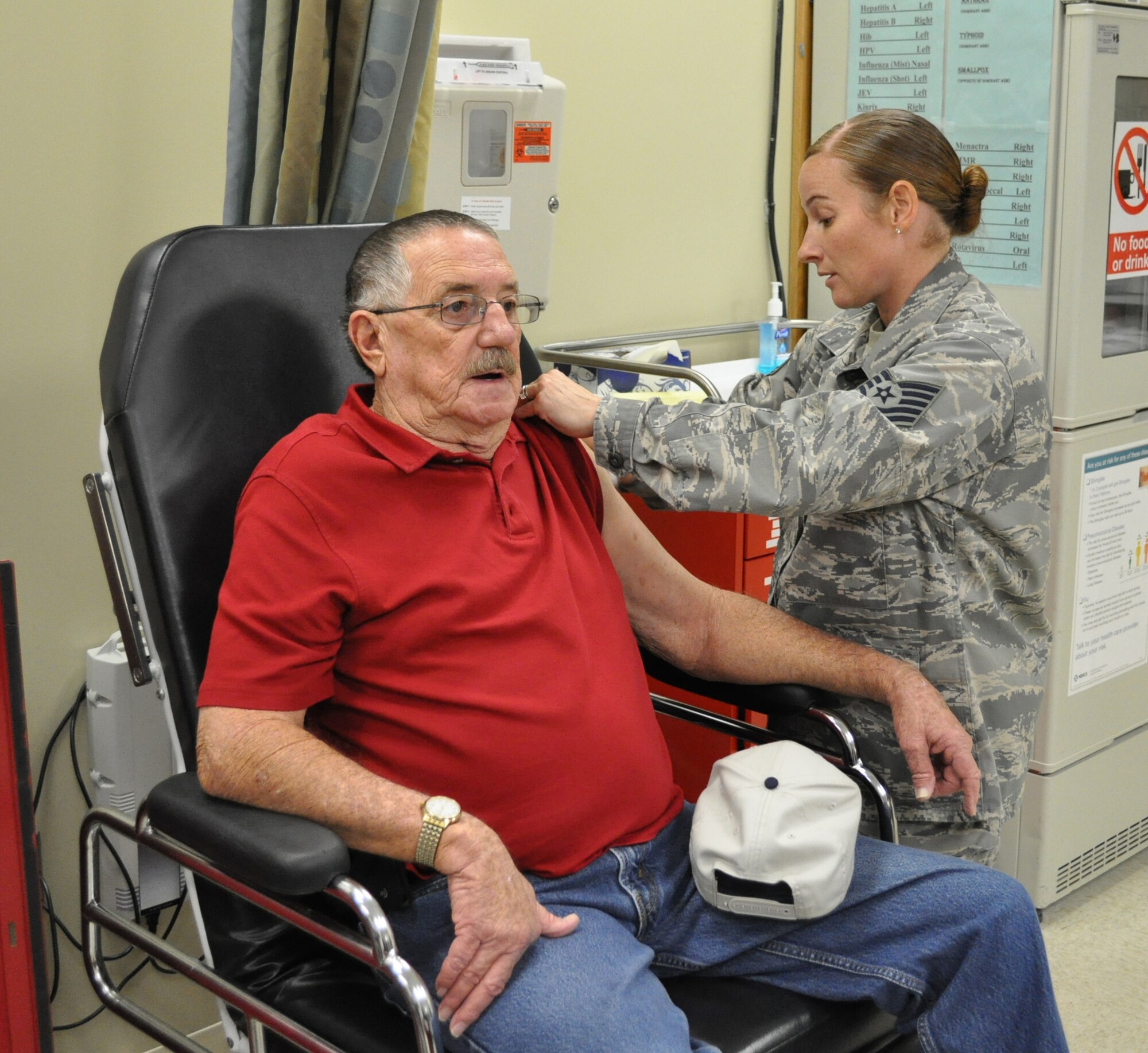 Tech. Sgt. Christine Boone, 72nd Medical Group immunization clinic, gives a flu shot to Bob Jeane, a retired Air Force technical sergeant, Wednesday. Flu shots are currently available for military members and TRICARE beneficiaries. Shots are given in the Immunization Clinic from 7 a.m. to 3:15 p.m. weekdays. The flu vaccine is not available on Tinker AFB for civilian employees. However, civilians are highly encouraged to receive the flu vaccine off base. Off-base options for the flu vaccine include a primary care physician’s office or local pharmacies. To find a location nearest you, visit: http://flushot.healthmap.org. (Air Force photo by Michael S. Della Vecchio)