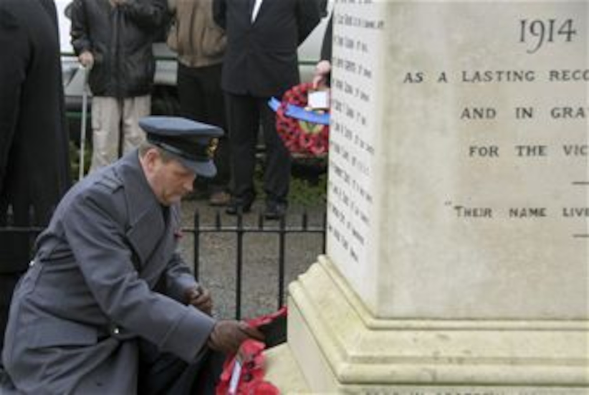 LAKENHEATH, England – Squadron Leader Jeremy Neild, RAF Lakenheath commander, places a wreath of red poppies on the Lakenheath War Memorial during a Remembrance Sunday ceremony. In the U.K., wearing red poppies and laying poppy wreaths at memorial sites is a way to remember those who lost their lives or were injured during war. (U.S. Air Force photo/Senior Airman Erin Mills)
