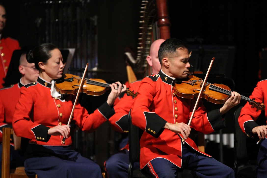 On Nov. 7, 2014, the Marine Chamber Orchestra and the Washington National Cathedral Choir performed a concert titled “Letters from War: A Tribute to Veterans” at the Washington National Cathedral. In addition to works such as John Williams’ Liberty Fanfare, The Lord is my Shepherd by John Rutter, and the Battle Hymn of the Republic, the moving tribute also included readings from letters sent from the font lines during the major conflicts of the past 100 years. Pictured, Staff Sgt. Chaerim Smith and Master Sgt. Regino Madrid. (U.S. Marine Corps photo by Gunnery Sgt. Amanda Simmons/released) 