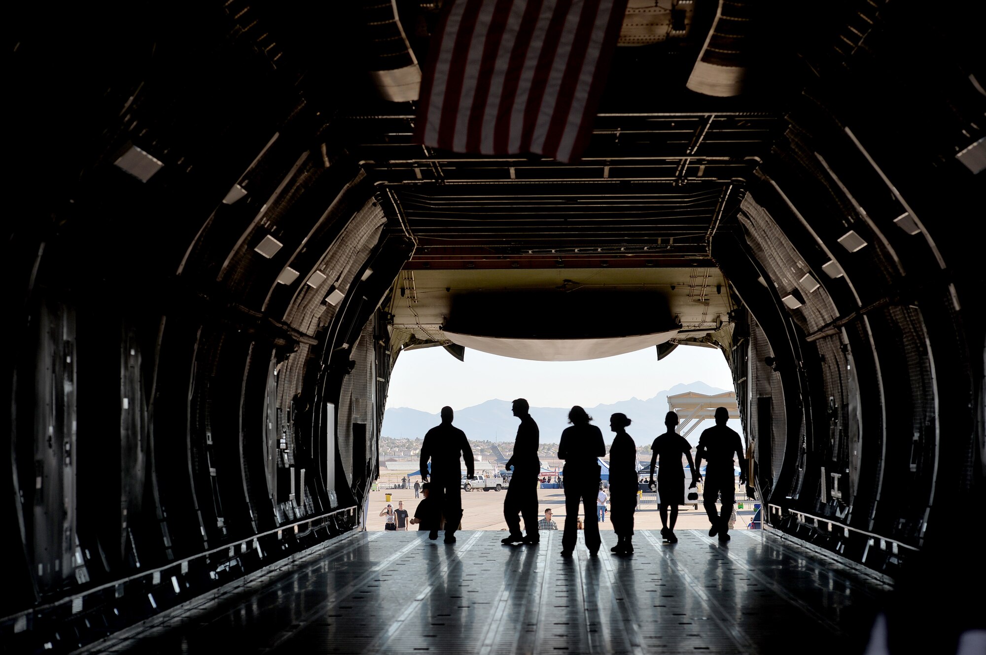 Visitors to the Nellis Open House walk through the cargo section of a C-5 Galaxy Nov. 7, 2014, at Nellis Air Force Base, Nev. The C-5 is one of the largest aircraft in the world and the largest airlifter in the Air Force inventory. The aircraft can carry a fully equipped combat-ready military unit to any point in the world on short notice and then provide the supplies required to help sustain the fighting force. (U.S. Air Force photo by Tech. Sgt. Nadine Barclay)