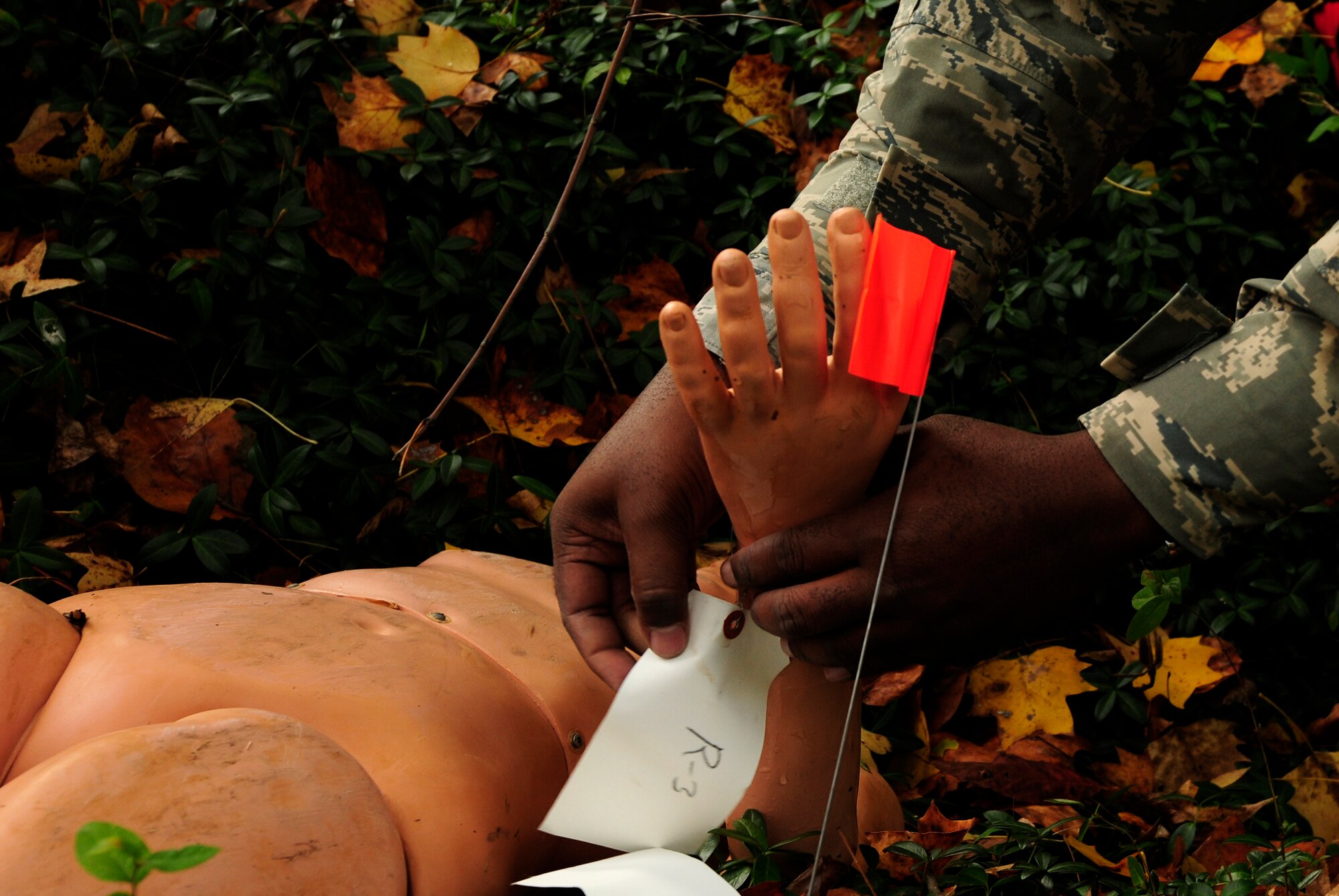 U.S. Air Force Tech. Sgt. Travis McDowell, 145th Force Support Squadron, tags a mannequin representing human remains during an annual Anti-Terrorism Exercise simulating a car-bomb detonation inside the perimeter of the North Carolina Air National Guard Base, Charlotte Douglas Intl. Airport, Nov. 1, 2014. The exercise initiated force protection measures across the base, testing the Wing’s ability to respond accordingly. After the car-bomb detonation, Airmen also performed simulated recovery procedures until conclusion of the exercise. (U.S. Air National Guard photo by Staff Sgt. Julianne M. Showalter, 145th Public Affairs/Released)