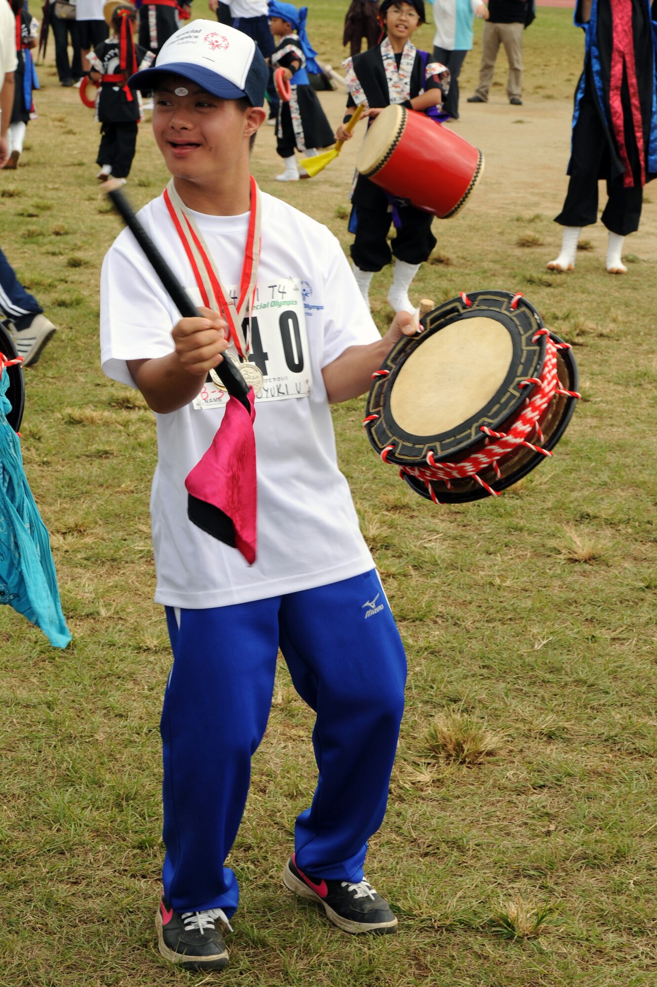 Hiroyuki Urasaki, Kadena Special Olympics athlete, bangs a drum during the closing ceremony of the Kadena Special Olympics on Kadena Air Base, Japan, Nov. 8, 2014. It was the 15th anniversary of KSO, a sporting event dedicated to enriching the lives of American and Okinawan special needs individuals on the island. (U.S. Air Force photo by Airman 1st Class Zade C. Vadnais/Released)