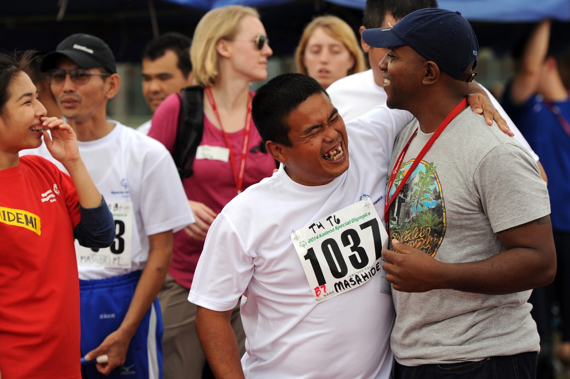 Masahide Higa, Kadena Special Olympics athlete, hugs U.S. Marine Corps Capt. Ron Davis, 3rd Marine Logistics Group future plans officer, at the Kadena Special Olympics on Kadena Air Base, Japan, Nov. 8, 2014. Close to 950 athletes attended KSO festivities, including approximately 2,500 American volunteers and language interpreters, along with senior officials from the Government of Japan, Okinawa Prefectural Government, local communities and the U.S. military. (U.S. Air Force photo by Airman 1st Class Zade C. Vadnais/Released)