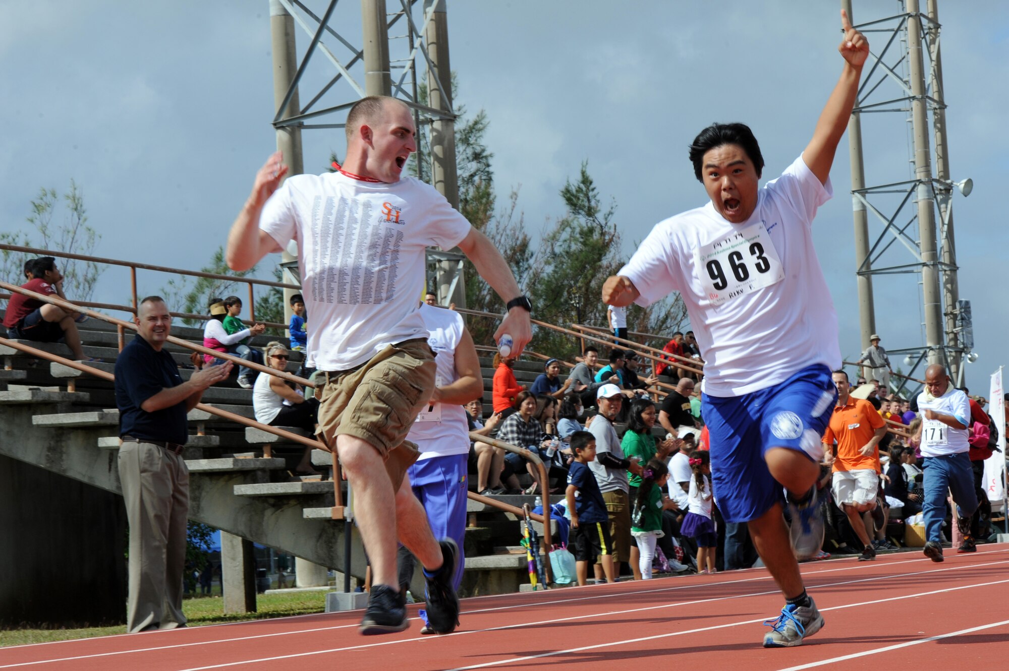 Riku Furuwaka, Kadena Special Olympics athlete, runs toward the finish line at the Kadena Special Olympics on Kadena Air Base, Japan, Nov. 8, 2014. KSO is a one-day sporting and entertainment event with approximately 950 special needs athletes and artists participating in a day of competition, music and special recognition. (U.S. Air Force photo by Airman 1st Class Zade C. Vadnais/Released)