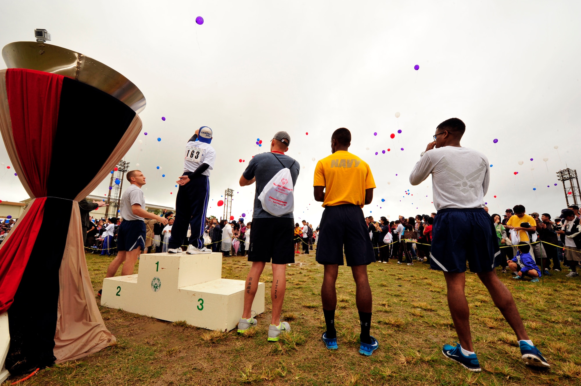 Kadena Special Olympics athletes, volunteers and supporters release balloons during the Special Olympics at the Kadena Air Base, Japan, Nov. 8, 2014. Approximately 2,500 volunteers helped nearly 950 athletes arrive to their events and compete in the largest overseas Special Olympics in the world. (U.S. Air Force photo by Naoto Anazawa/Released)