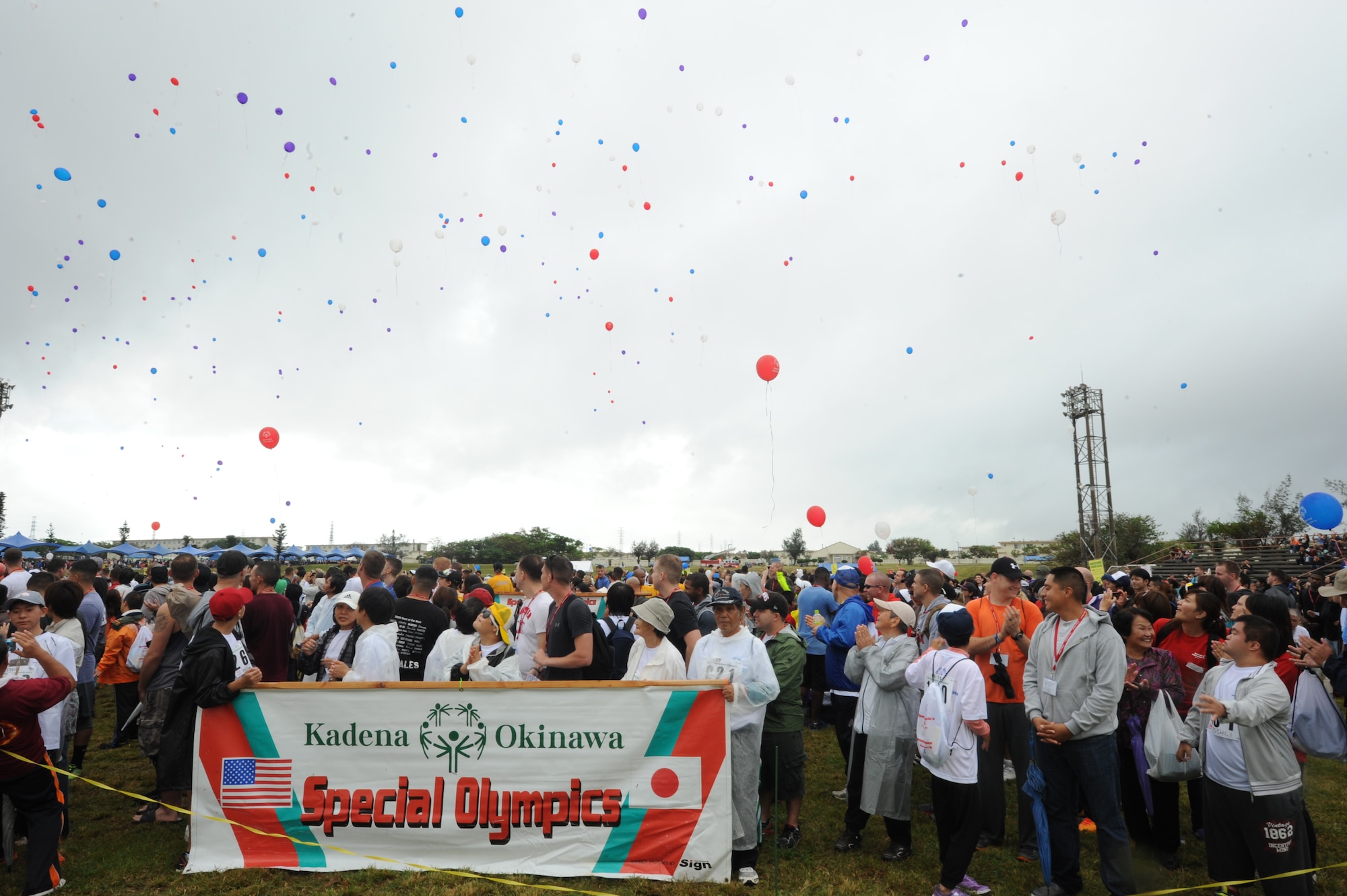 U.S. Air Force firefighters from the 18th Civil Engineer Squadron spray water over buses filled with Special Olympics athletes as they arrive at the Kadena Special Olympics on Kadena Air Base, Japan, Nov. 8, 2014. KSO has been conducted by Kadena every year since 2000 and was established by the 18th Wing commander. KSO features wholesome sporting and entertainment, and the communities involved stand together to support and enable it. (U.S. Air Force photo by Airman 1st Class Stephen G. Eigel/Released)