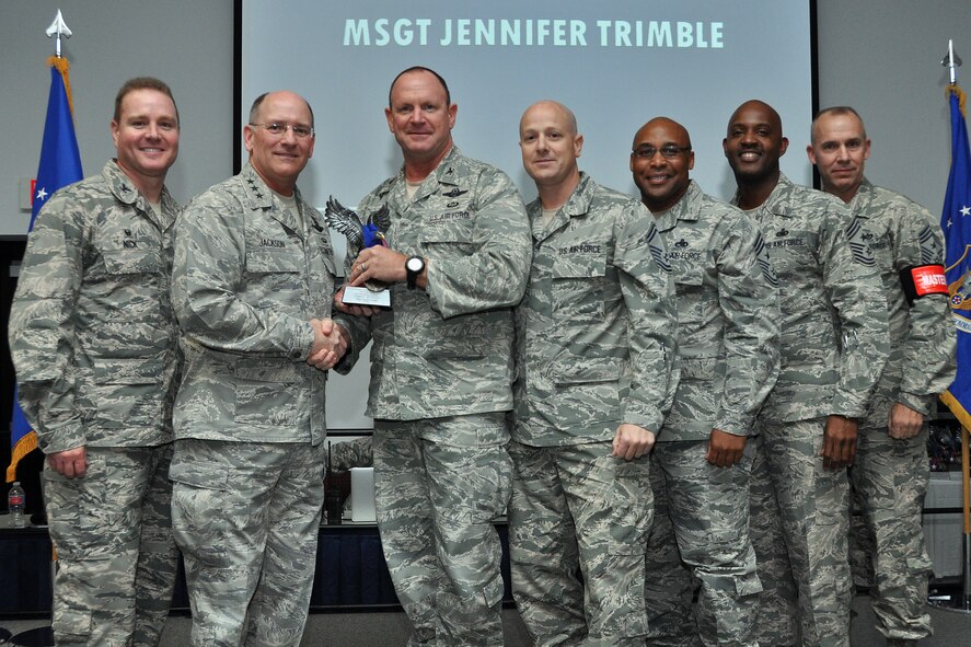 Lt. Gen. James Jackson, chief of the Air Force Reserve, Headquarters U.S. Air Force Washington, D.C., presents the Recruiter Service Personnel Support Person of the Year Award to Col. Chris Funk, 482nd Fighter Wing commander, Homestead Air Reserve Base, Fla., who accepts on behalf of Master Sgt. Jennifer Trimble, chief of career development for the 482nd Force Support Squadron at Homestead ARB, during the Recruit National Awards Banquet at the Combat Readiness Training Center in Savannah, Ga. Trimble received this award because of her professionalism and diligence while aiding nationwide recruiting efforts. (Courtesy photo)