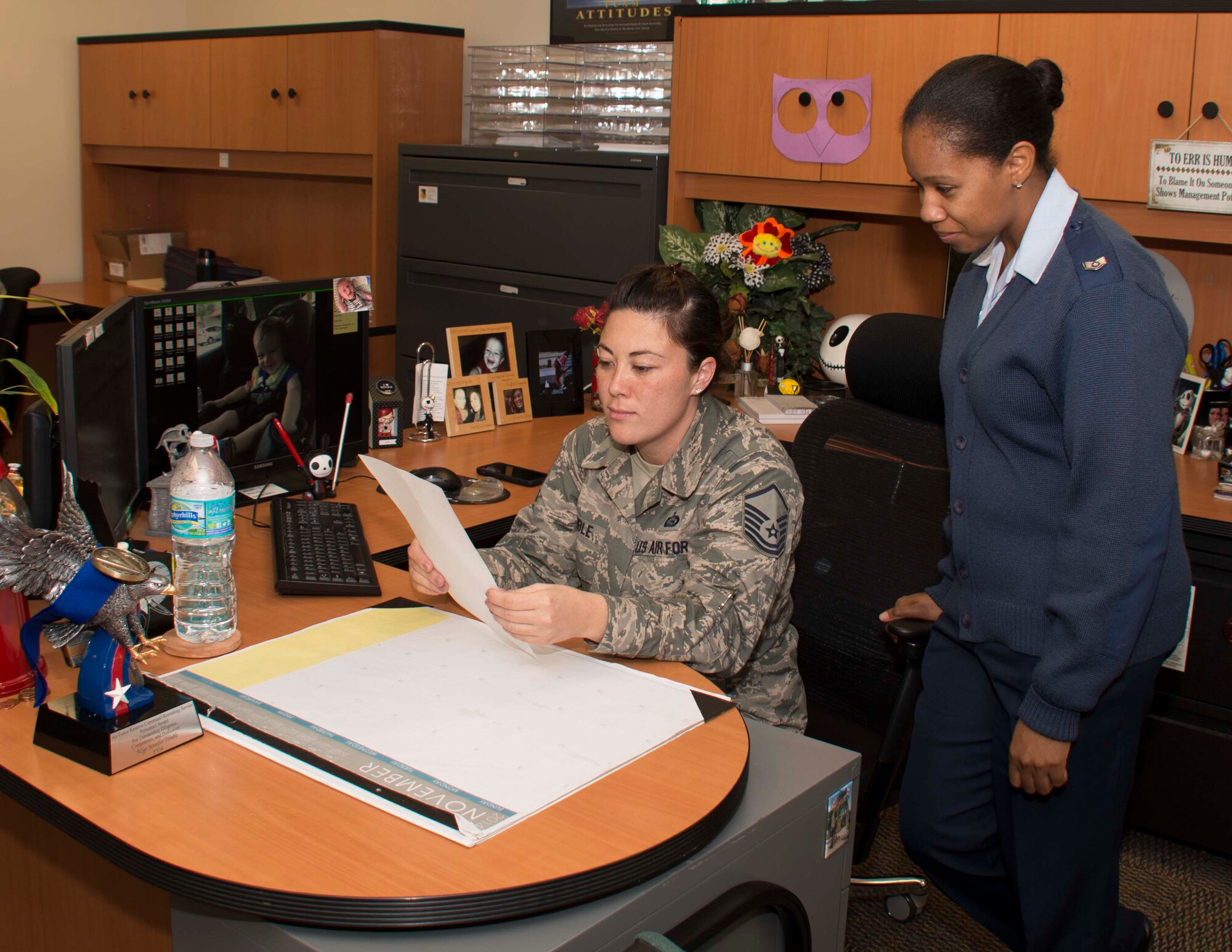 Master Sgt. Jennifer Trimble, chief of career development for 482nd Force Support Squadron, assists an Airman with inbound paperwork at Homestead Air Reserve Base, Fla., on Nov. 9. Trimble received the Recruiter Service Personnel Support Person of the Year Award because of her outstanding customer service and professionalism aiding nationwide recruiting efforts. (U.S. Air Force photo by Senior Airman Aja Heiden)