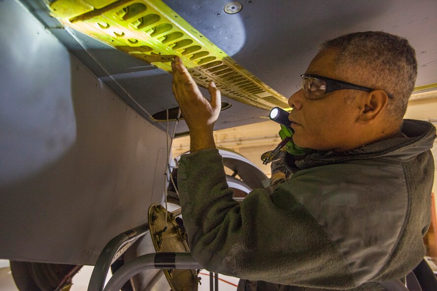 Staff Sgt. Ivan R. Martinez, 108th Wing Aircraft Maintenance Squadron, New Jersey Air National Guard, checks for evidence of fuel leaks during a periodic inspection of a KC-135R Stratotanker at Joint Base McGuire-Dix-Lakehurst, N.J., Nov. 8, 2014. (U.S. Air National Guard photo by Master Sgt. Mark C. Olsen/Released)