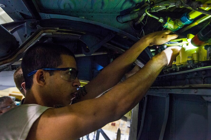 Airman 1st Class Bryant Torro, 108th Wing Maintenance Squadron, New Jersey Air National Guard, disconnects an inboard and outboard spoiler spring cartridge during a periodic inspection of a KC-135R Stratotanker at Joint Base McGuire-Dix-Lakehurst, N.J., Nov. 8, 2014. (U.S. Air National Guard photo by Master Sgt. Mark C. Olsen/Released)