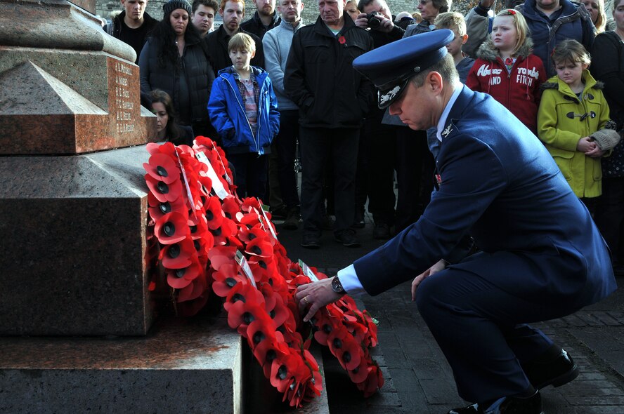 U.S. Air Force Col. William Holt, Joint Special Operations Air Component - Europe commander, lays a wreath at the base of the War Graves Memorial for Remembrance Day and the 100th anniversary of the start of World War I in Thetford, Suffolk, England, Nov. 9, 2014. Remembrance Day is annually observed in November to commemorate the sacrifices of service members for all armed conflicts. (U.S. Air Force photo by Tech. Sgt. Stacia Zachary/Released)
