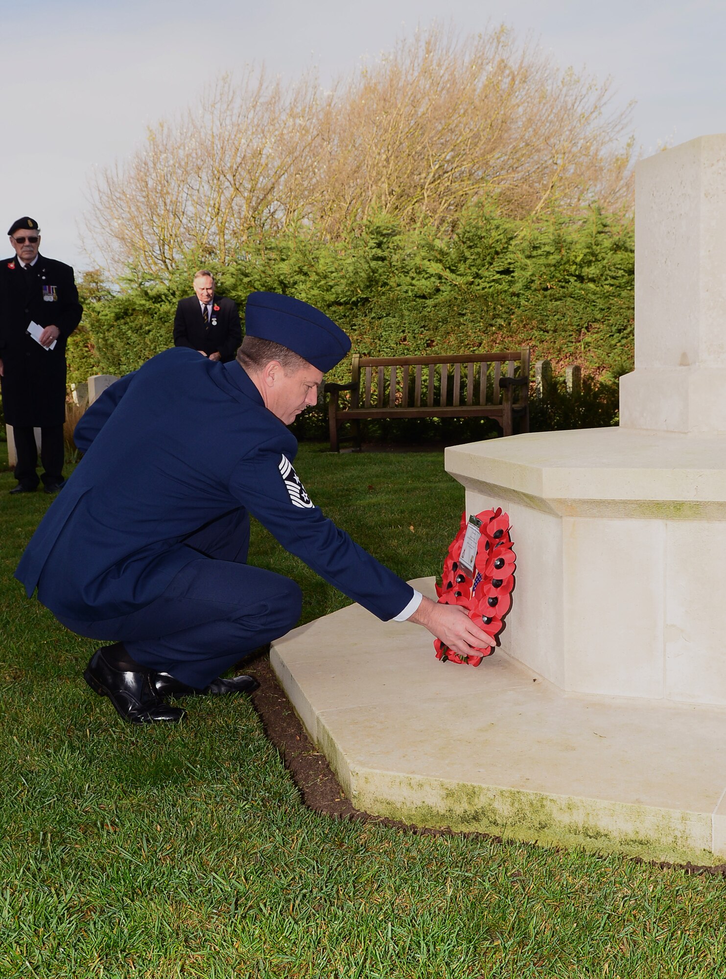 U.S. Air Force Chief Master Sgt. Tracey Jones, 100th Air Refueling Wing command chief, lays a wreath at the base of the War Graves Memorial during a Remembrance Day wreath-laying ceremony Nov. 9, 2014, in Beck Row, Suffolk, England. Remembrance Day is held annually in November as a way to pay respect to military members who lost their lives. (U.S. Air Force photo by Airman 1st Class Jonathan Light/Released)
