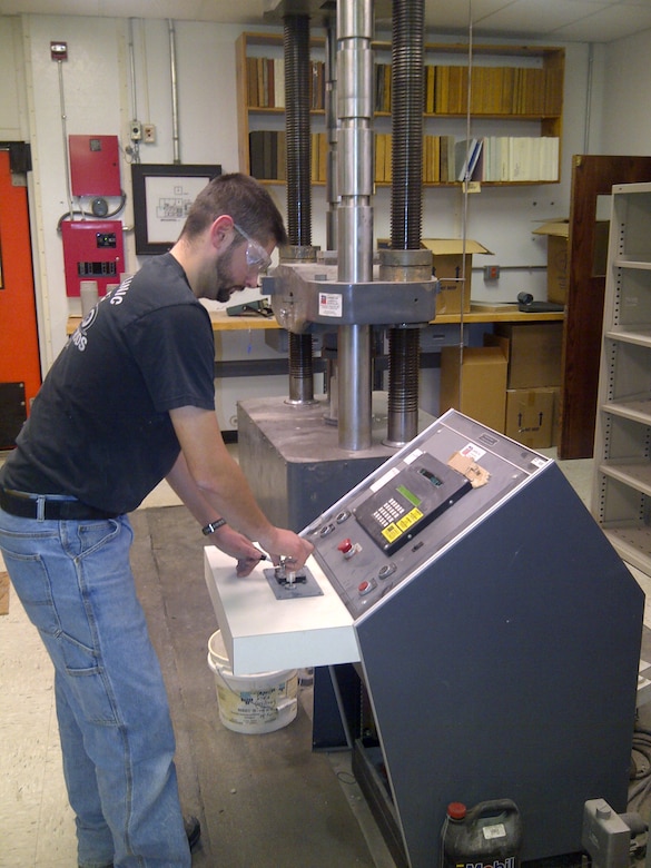 TJ Melendy, research civil engineer in the Force Projection and Sustainment Branch at CRREL, tests the unconfined compressive strength of a novel cold weather concrete developed for the US Air Force Civil Engineering Center (AFCEC) as part of its Rapid Runway Repair Modernization Program.