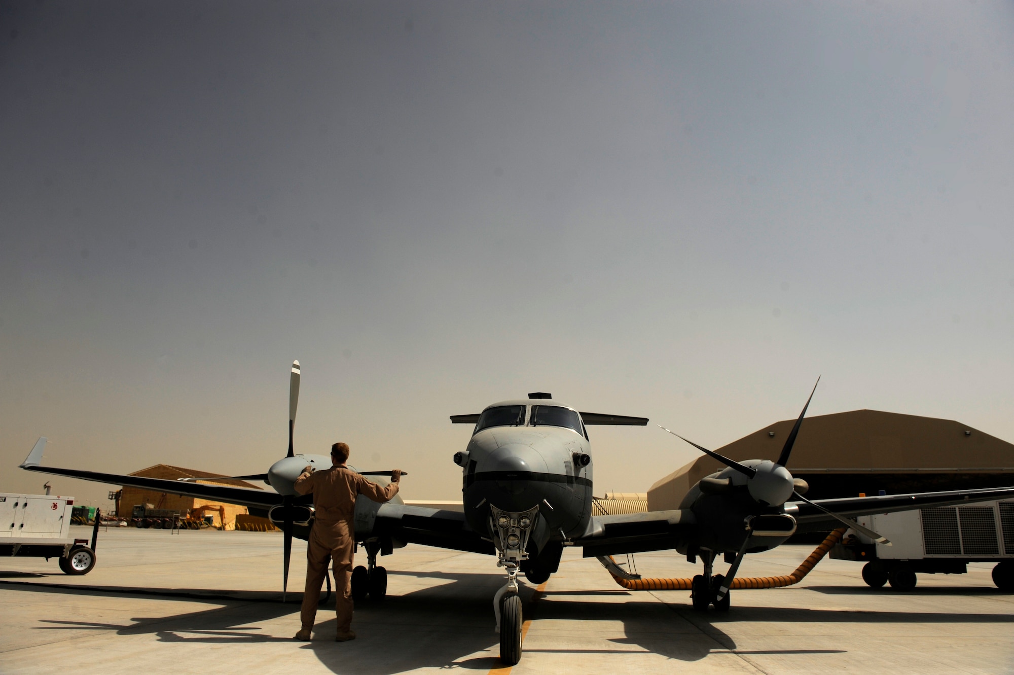 Airmen from the 361st Expeditionary Reconnaissance Squadron prepare an MC-12W Liberty for operations Aug. 25, 2010, on Kandahar Airfield, Afghan.  The MC-12W provides full-motion video and signals intelligence to assist battlefield commanders. (U.S. Air Force photo/Staff Sgt. Eric Harris) 