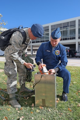Academy Cadets 1st Class Max Johnson and Kyle Morse repack an airdrop practice model Nov. 6, 2014, at the U.S. Air Force Academy, Colo. The model was created by a 2014 capstone project team working to mathematically model wind shear and speed to decrease the cost and increase the accuracy of combat zone airdrops. (U.S. Air Force photo) 