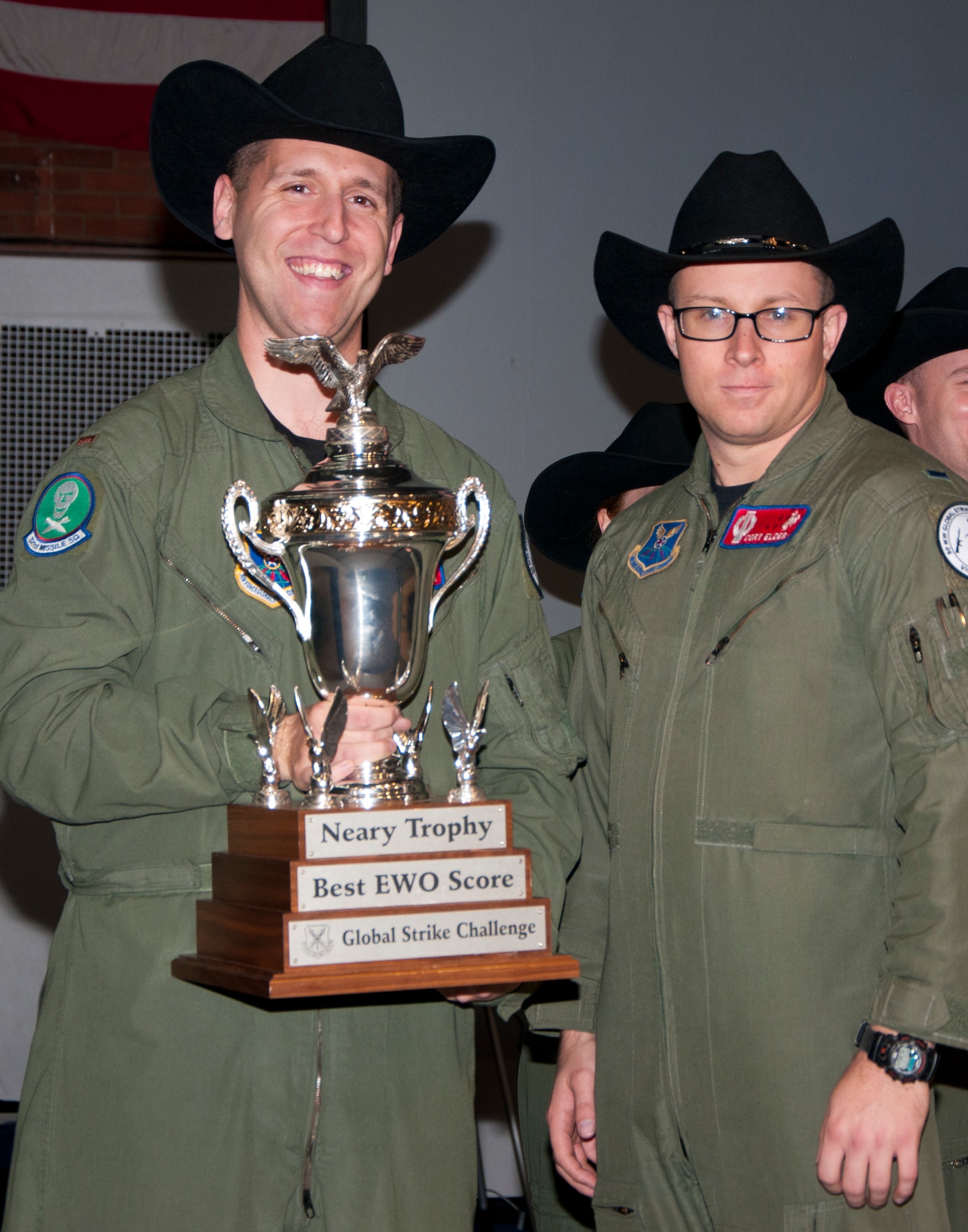 Second Lt. Nicholas Vaughn, 321st Missile Squadron deputy missile combat crew commander, and 1st Lt. Corey Elder, 320th MS missile combat crew commander, pose with the Neary Trophy Nov. 7, 2014, in the Fall Hall Community Center on F.E. Warren Air Force Base, Wyo. The two lieutenants won the trophy in the 2014 Global Strike Challenge competition. The trophy is presented to the team who performs emergency war orders the best during the challenge. (U.S. Air Force photo by Senior Airman Jason Wiese)