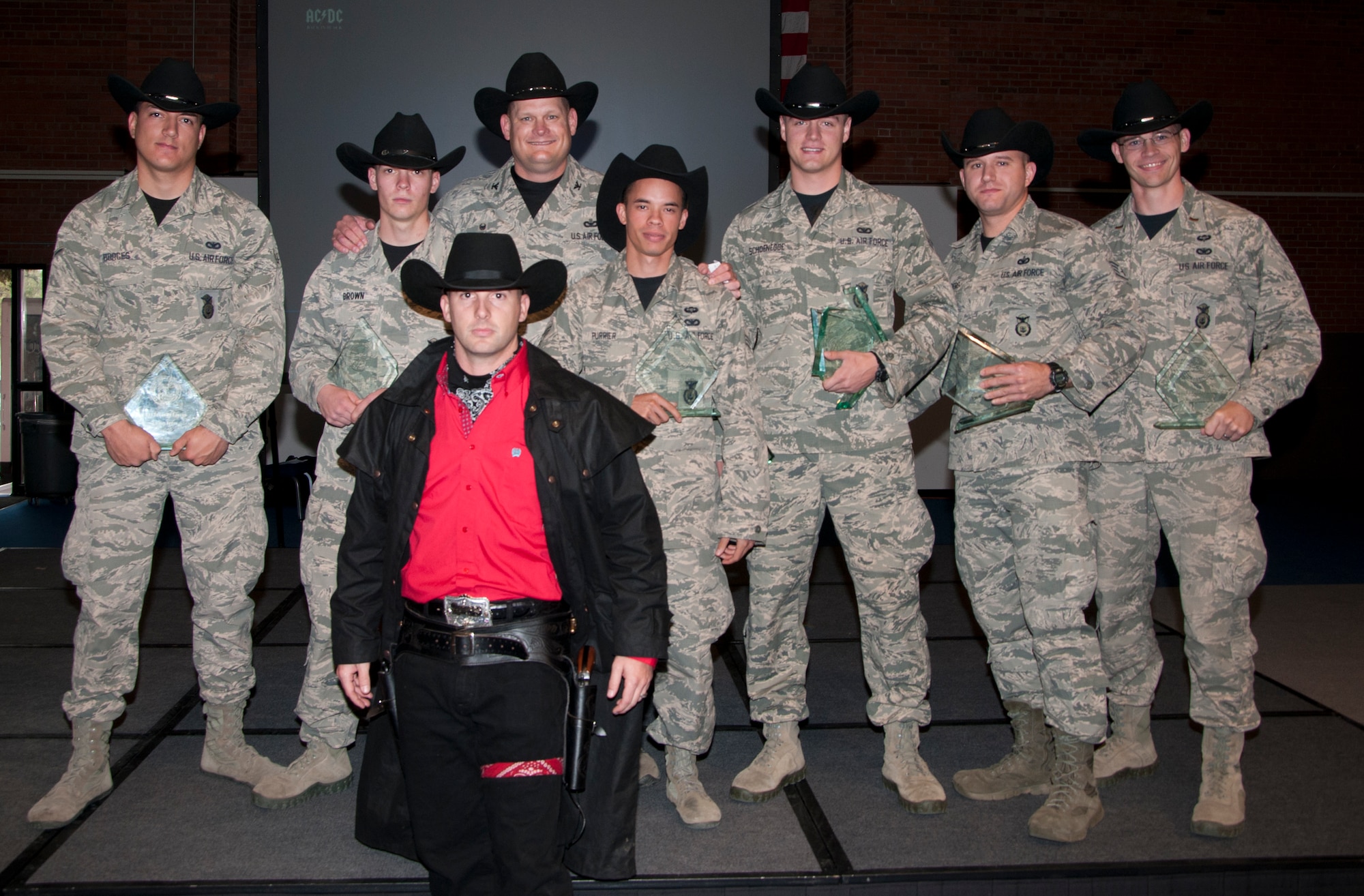 The Warren Wrangler, the 90th Missile Wing's official Global Strike Challenge Mascot, poses with the 90th Security Forces Group 2014 Global Strike Challenge competitors and Col. Craig Allton, 90th SFG commander, Nov. 7, 2014, in the Fall Hall Community Center on F.E. Warren Air Force Base, Wyo. The 90th SFG team won the Best Security Forces Firing Team award during the competition and Senior Airman Colton Schoenegge, 90th SFG Tactical Response Force, won  both the M-9 and M-240 firing awards. (U.S. Air Force photo by Senior Airman Jason Wiese)
