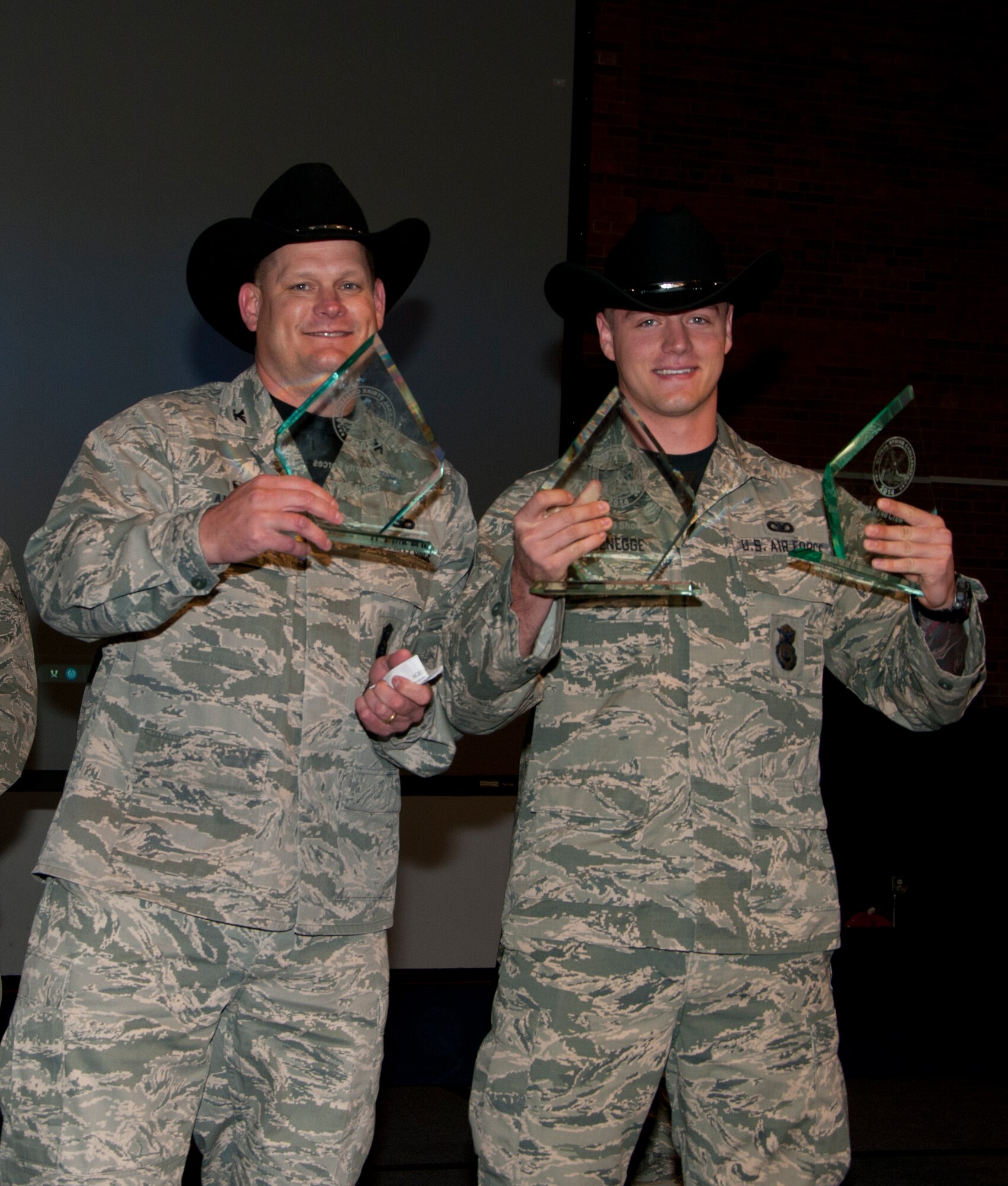 Col. Craig Allton, 90th Security Forces Group commander, and Senior Airman Colton Schoenegge, 90th SFG Tactical Response Force, Nov. 7, 2014, in the Fall Hall Community Center on F.E. Warren Air Force Base, Wyo., hold the awards Schoenegge and the rest of the 90th SFG 2014 Global Strike Challenge team won during the competition. The 90th SFG team won the Best Security Forces Firing Team award and Schoenegge won  both the M-9 and M-240 firing awards. (U.S. Air Force photo by Senior Airman Jason Wiese)