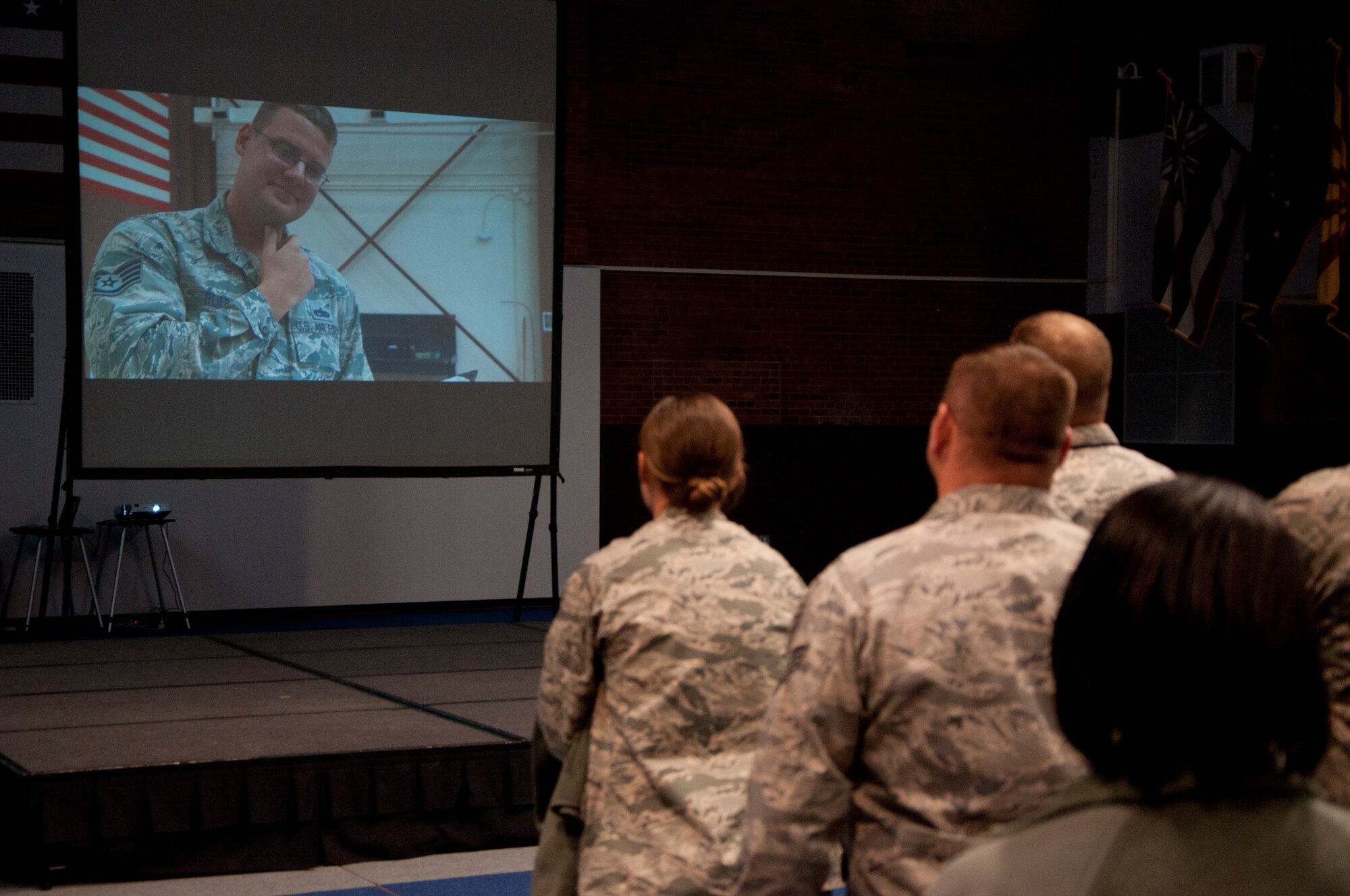 A crowd watches the 90th Missile Wing's 2014 Global Strike Challenge video in the Fall Hall Community Center on F.E. Warren Air Force Base, Wyo., Nov. 7, 2014. The video introduced the various organizations competing and showcased some of the skills used during the challenge. (U.S. Air Force photo by Senior Airman Jason Wiese)
