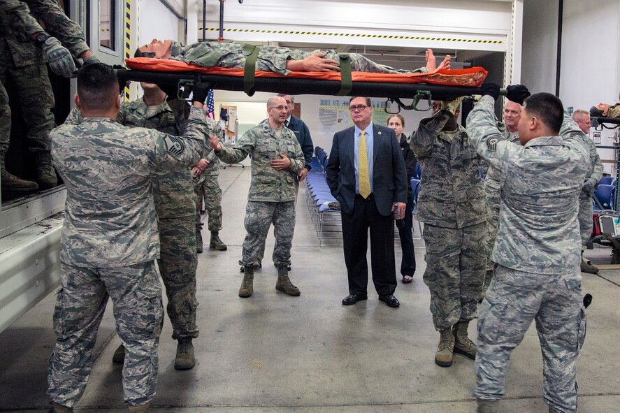 U.S. Rep. Denny Heck, of Washington's 10th District, listens to Capt. Paul Hall (left of Congressman), a 446th Aeromedical Staging Squadron operations officer, brief him on the intricacies of the patient-movement process they implement when deployed in theater, as members of the squadron demonstrate it, Nov. 5 at McChord Field. Heck's purpose for visiting the Reserve unit was to get an update on the status of the wing. Various 446th members briefed the Congressman on medical service missions, and Operation Deep Freeze. (U.S. Air Force Reserve photo by Jake Chappelle)