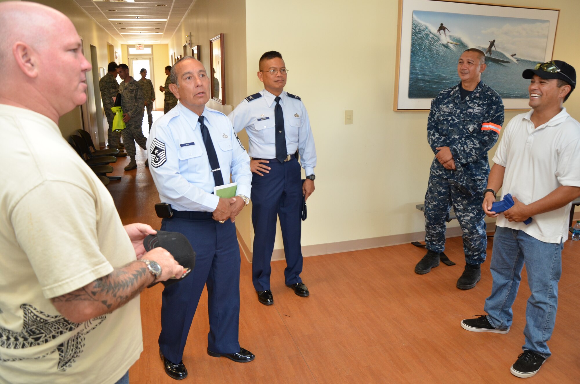 From left, Master-at-Arms Second Class Morgan Hill, a police officer with the Honolulu Police Department (HPD); Chief Master Sgt. Joseph Vigil, command chief of the 624th Regional Support Group; Col. Maynard “Max” Mendoza, commander of the 624th RSG; Master-at-Arms Second Class Antonio Bello, a Department of the Army police officer; and Master-at-Arms First Class Tony Ozoa, an HPD officer, muster in the foyer of building 4100 after giving the “all clear” announcement during an active shooter exercise the 624th RSG staged during a unit training assembly, Joint Base Pearl Harbor-Hickam, Hawaii, Sept. 9, 2014. Hill, Bello, Ozoa and Master-at-Arms Second Class Darrell Jones, also an HPD officer (not pictured),  are all reservists with the Naval Security Force, Naval Intelligence Operations Center (NIOC), Schoefield Barracks, Hawaii, who helped give 624th RSG members a chance to practice their reaction skills in an active shooter scenario. (U.S. Air Force photo by Tech. Sgt. Phyllis Keith)