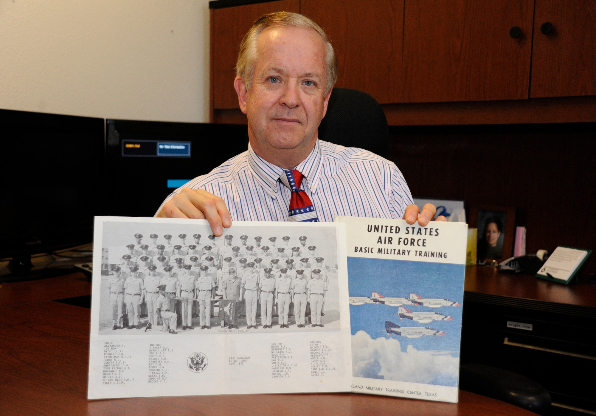 Lynn Coggins, 533rd Training Squadron chief of training management flight, poses with a photo of his flight from Basic Military Training, Nov. 7, 2014, Vandenberg Air Force Base, Calif. Veterans Day is a nationally celebrated holiday that honors those who have served in the United States Armed Forces. (U.S. Air Force photo by Airman Robert J. Volio/Released)