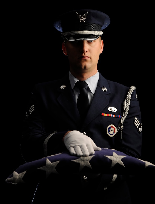 A Joint Base Andrews Honor Guardsman poses for a photo Nov. 07. 2014. The American flag is presented as it is during funerals for deceased military vetarans when passing the flag to the next-of-kin. (U.S. Air Force photo/SSgt Nichelle Anderson)