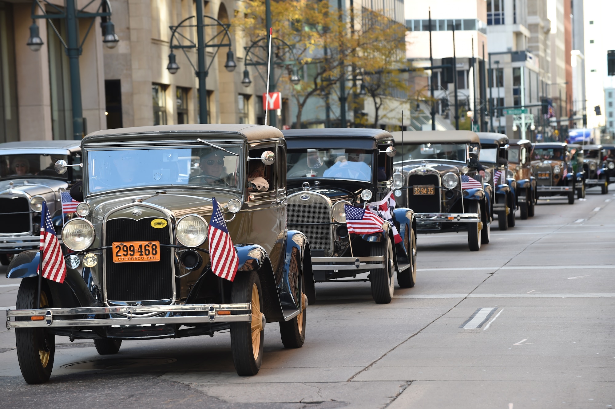 A row of vintage cars driven by military veterans line the street during the Veteran’s Day Parade, hosted by the Colorado Veterans Project, Nov. 8, 2014, in Denver. The parade consisted of more than 75 groups honoring American veterans by highlighting each American war, beginning with the Revolutionary War and ending with Operation Iraqi Freedom. (U.S. Air Force photo by Airman 1st Class Samantha Saulsbury/Released)