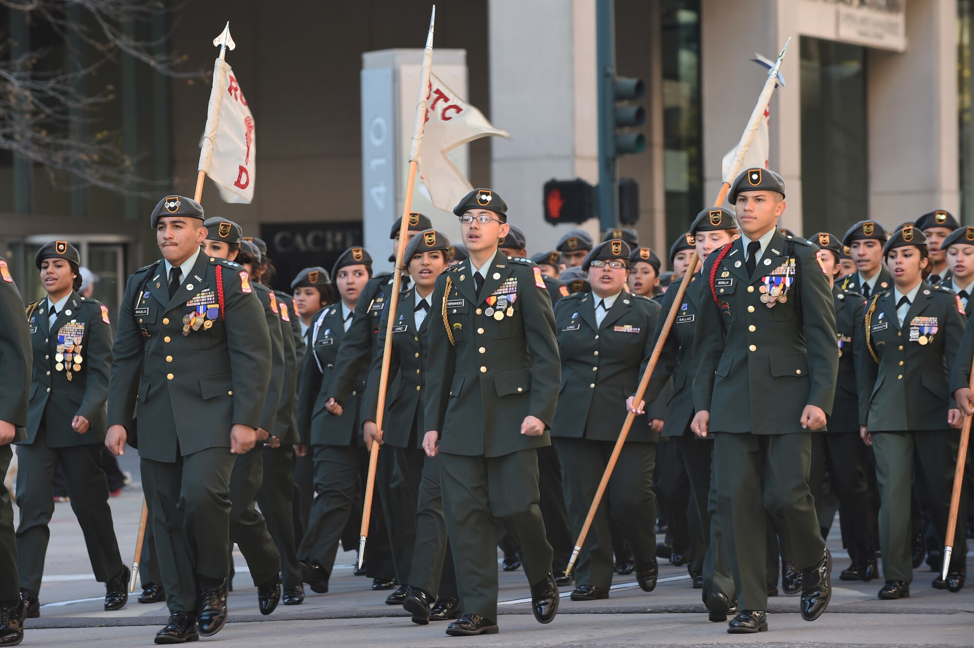An Army Junior ROTC team marches in the Veteran’s Day Parade, hosted by the Colorado Veterans Project,  Nov. 8, 2014, in Denver. The parade consisted of more than 75 groups honoring American veterans by highlighting each American war, beginning with the Revolutionary War and ending with Operation Iraqi Freedom. (U.S. Air Force photo by Airman 1st Class Samantha Saulsbury/Released)
