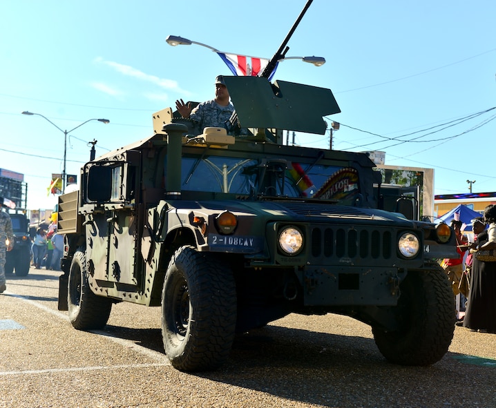 Service members from the Louisiana National Guard drive a High Mobility Multipurpose Wheeled Vehicle during the 2014 Veterans Day parade on Shreveport, La., Nov. 9, 2014.  The HMMWV is an all-wheel drive military automobile designed primarily for personnel and light cargo transport behind enemy lines. (U.S. Air Force photo/Airman 1st Class Mozer Da Cunha)