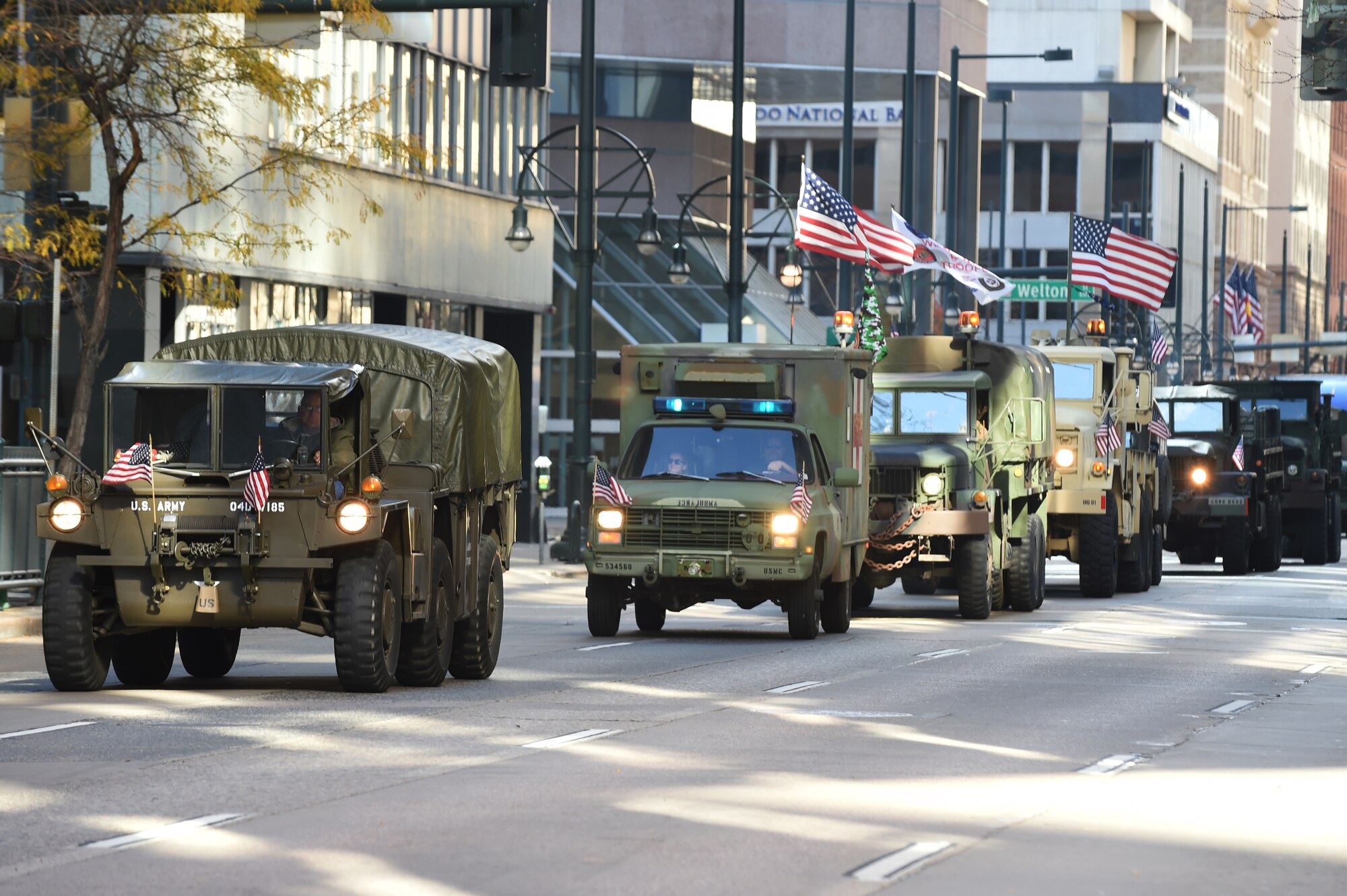 A convoy driven by military members lines the street during the Veteran’s Day Parade, hosted by the Colorado Veterans Project, Nov. 8, 2014, in Denver. The parade consisted of more than 75 groups honoring American veterans by highlighting each American war, beginning with the Revolutionary War and ending with Operation Iraqi Freedom. (U.S. Air Force photo by Airman 1st Class Samantha Saulsbury/Released)