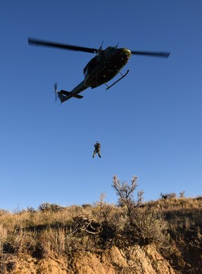 Tech. Sgt. Michelle Bresson, 40th Helicopter Squadron special missions aviator, hoists down Maj. Rhodora Beckinger, 341st Medical Operations flight doctor, during a search and rescue training exercise Nov. 5. One of the more memorable missions Bresson has been a part of would most likely be her first search and rescue mission where they rescued an injured male on the night of his bachelor party, she said. (U.S. Air Force photo/Airman 1st Class Joshua Smoot)