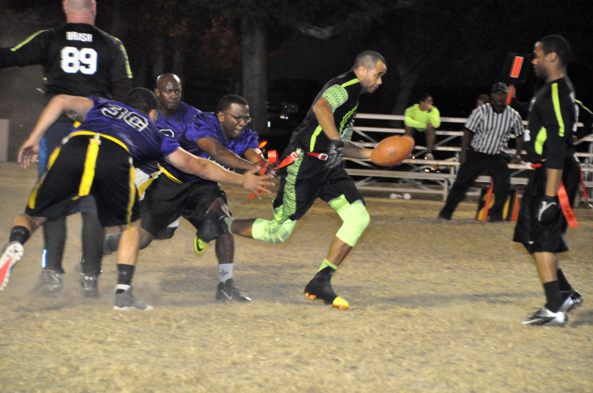 403rd team members stretch to snatch a Youn Gun flag during the Keesler Air Force Base flag football championship game Nov 4. (U.S. Air Force photo by/Master Sgt. Brian Lamar)