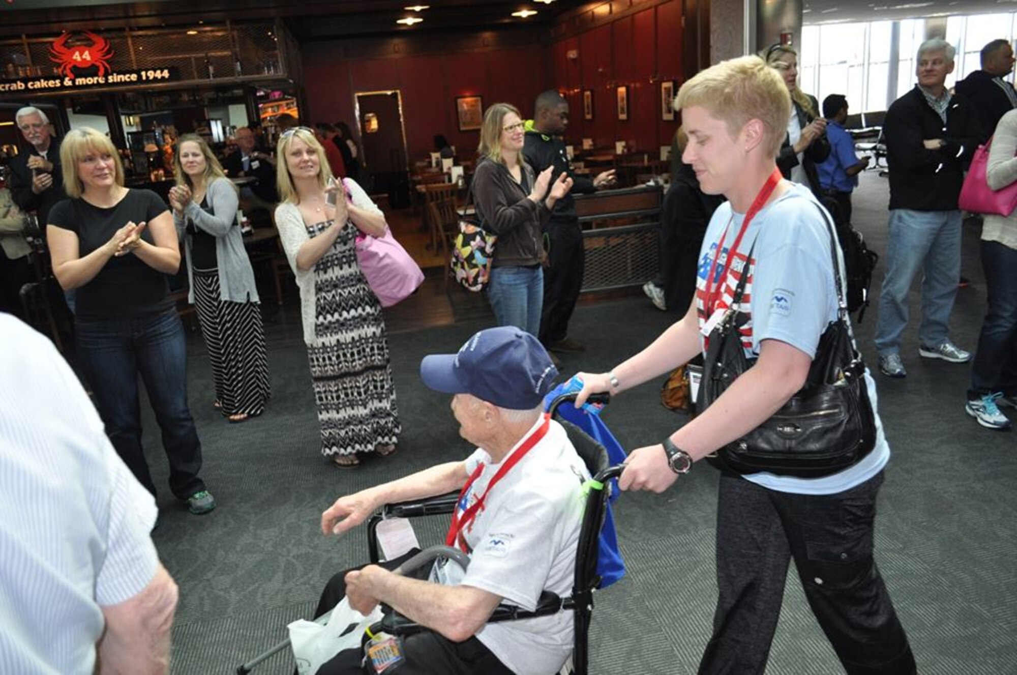 Capt. Carmen Sowers, 319th Recruiting Squadron support flight commander (right), regularly thanks WWII veterans for their service during her travels to Washington, D.C. on Honor Flights. For Sowers, Veterans Day is a day to thank all veterans and reflect on how they made a positive impact on her life. (Courtesy photo) 