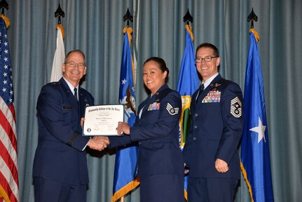 U.S. Air Force members at Joint Base San Antonio receive their Community College of the Air Force degrees Nov. 7, at a ceremony in the Fleenor Auditorium at Joint Base San Antonio-Randolph.  CCAF is federally-chartered degree-granting institution that serves the United States Air Force’s enlisted total force.  (U.S. Air Force photo/Desiree Palacios)