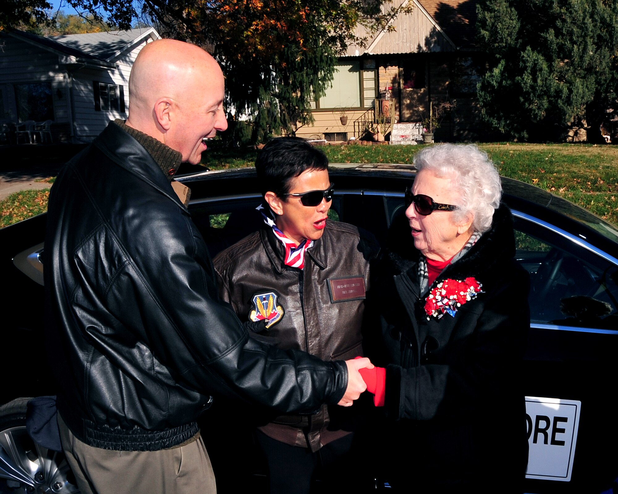Nebraska Governor Pete Ricketts shakes hands with Kathryn Shudak, a former "Rosie the Riveter" who worked at the Martin Bomber building on Offutt Air Force Base, Neb. during WWII. Shudak was the guest of honor for the annual Veterans Day Parade in Bellevue Nov. 8. Bellevue Mayor Rita Sanders was on hand for the annual parade that runs along Mission Avenue and ends with the annual chili/soup feed at Mission Middle School. (U.S. Air Force photo by D.P. Heard/Released)