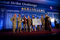 Leadership from the 5th Bomb Wing and 91st Missile Wing pose for a photo after winning the first-ever innovation award during the Global Strike Challenge score posting event on Barksdale Air Force Base, La., Nov. 5, 2014. GSC is the world's premier bomber, Intercontinental Ballistic Missile, helicopter operations and security forces competition with units from Air Force Global Strike Command, Air Combat Command, Air Force Reserve Command and the Air National Guard. (U.S. Air force photo/Senior Airman Brittany Y. Bateman)