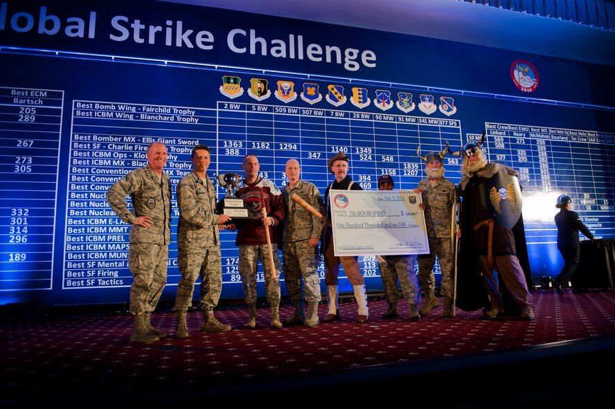 Leadership from the 5th Bomb Wing and 91st Missile Wing pose for a photo after winning the first-ever innovation award during the Global Strike Challenge score posting event on Barksdale Air Force Base, La., Nov. 5, 2014. GSC is the world's premier bomber, Intercontinental Ballistic Missile, helicopter operations and security forces competition with units from Air Force Global Strike Command, Air Combat Command, Air Force Reserve Command and the Air National Guard. (U.S. Air force photo/Senior Airman Brittany Y. Bateman)