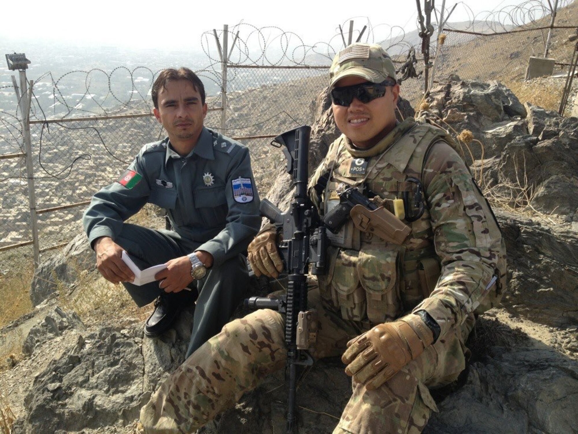 Capt. Eumir Arceo, 364th Recruiting Squadron operations officer (right), deployed as a communications advisor with the Afghan National Police in 2012. After joining Air Force Recruiting Service, he has been able to use his experiences as an immigrant from the Philippines to connect with some high school students. For Arceo, Veterans Day is a day to remember the men and women who paved the way for him to be able to serve in the military. (Courtesy photo)

