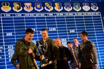 The 91st Missile Wing celebrates after winning best helicopter emergency security response crew, best search and rescue crew and the Bourland Trophy during the Global Strike Challenge score posting event on Barksdale Air Force Base, La., Nov. 5, 2014. Participants in the 2014 GSC included Air Force Global Strike Command's six wings plus units from Air Combat Command, Air Force Reserve Command and the Air National Guard. (U.S. Air force photo/Senior Airman Brittany Y. Bateman)