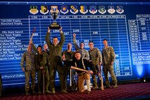 The 91st Missile Wing celebrates after winning best helicopter emergency security response crew, best search and rescue crew and the Bourland Trophy during the Global Strike Challenge score posting event on Barksdale Air Force Base, La., Nov. 5, 2014. Participants in the 2014 GSC included Air Force Global Strike Command's six wings plus units from Air Combat Command, Air Force Reserve Command and the Air National Guard. (U.S. Air force photo/Senior Airman Brittany Y. Bateman)