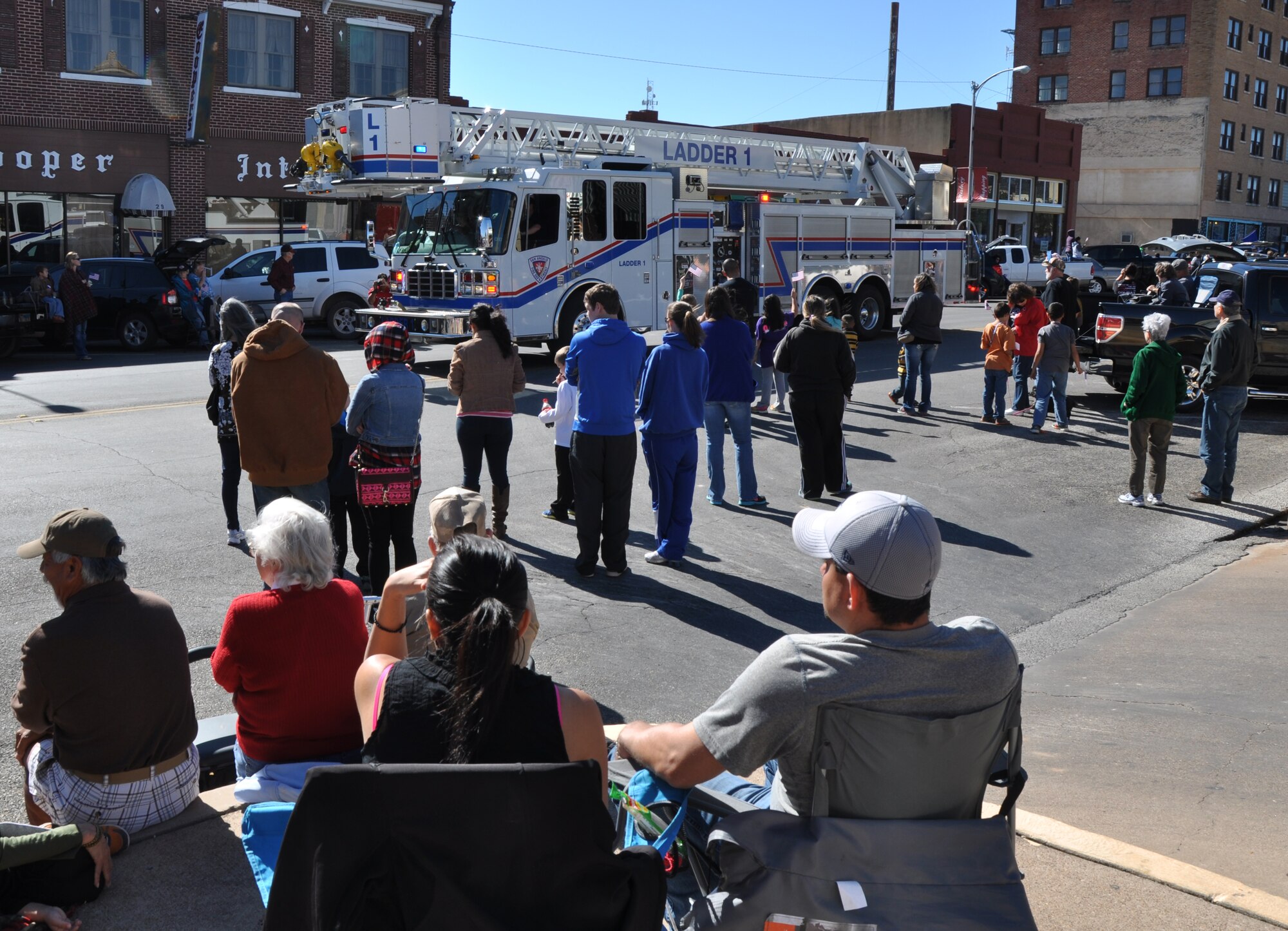 SAN ANGELO, Texas – Parade goers watch as a San Angelo Fire Department fire truck drives by during the Veterans Day parade downtown Nov. 8. The San Angelo community and Team Goodfellow hosted the parade to honor veterans for their service and sacrifice. (U.S. Air Force photo/ Senior Airman Joshua Edwards)