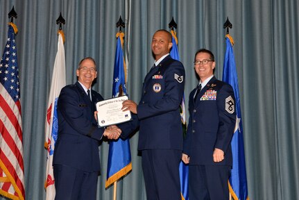 U.S. Air Force members at Joint Base San Antonio receive their Community College of the Air Force degrees Nov. 7, at a ceremony in the Fleenor Auditorium at Joint Base San Antonio-Randolph.  CCAF is federally-chartered degree-granting institution that serves the United States Air Force’s enlisted total force.  (U.S. Air Force photo/Desiree Palacios)