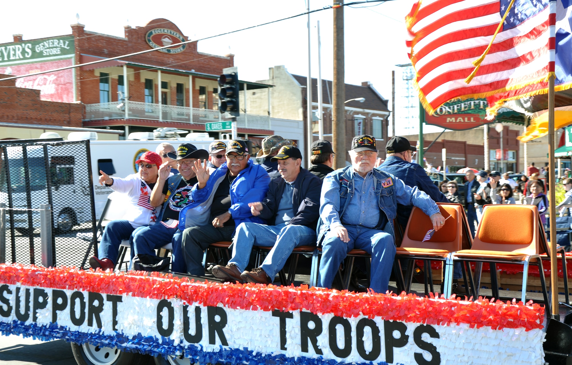 SAN ANGELO, Texas – Veterans wave to the crowd during the Veterans Day parade downtown Nov. 8. This group of veterans served during the Vietnam War. (U.S. Air Force photo/ Senior Airman Joshua Edwards)