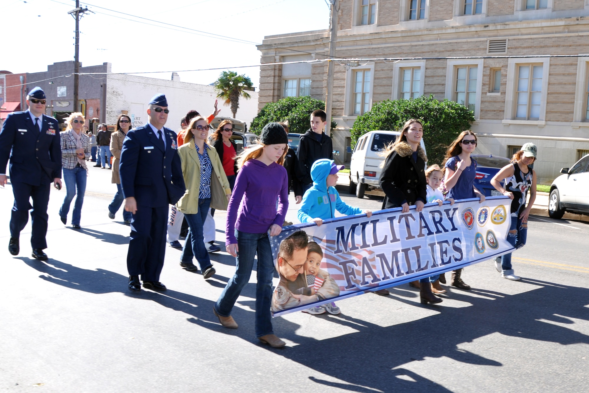 SAN ANGELO, Texas – A group of military family members march in the Veterans Day parade downtown Nov. 8. The military families were just one of the dozens of groups in the parade showing their support to veterans. (U.S. Air Force photo/ Senior Airman Joshua Edwards)