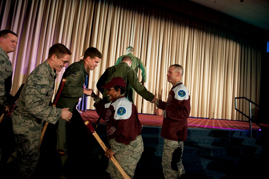 Col. Mike Lutton, 91st Missile Wing commander, and Chief Master Sgt. Felica Noil, 91st MW command chief, shake hands with the winners of the Bourland Trophy during the Global Strike Challenge score posting event on Barksdale Air Force Base, La., Nov. 5, 2014. The score posting event connects the command's heritage and mission, while at the same time recognizing and celebrating the "best of the best" in technical and weapons system expertise in the bomber, missile and security forces areas. (U.S. Air force photo/Senior Airman Brittany Y. Bateman)